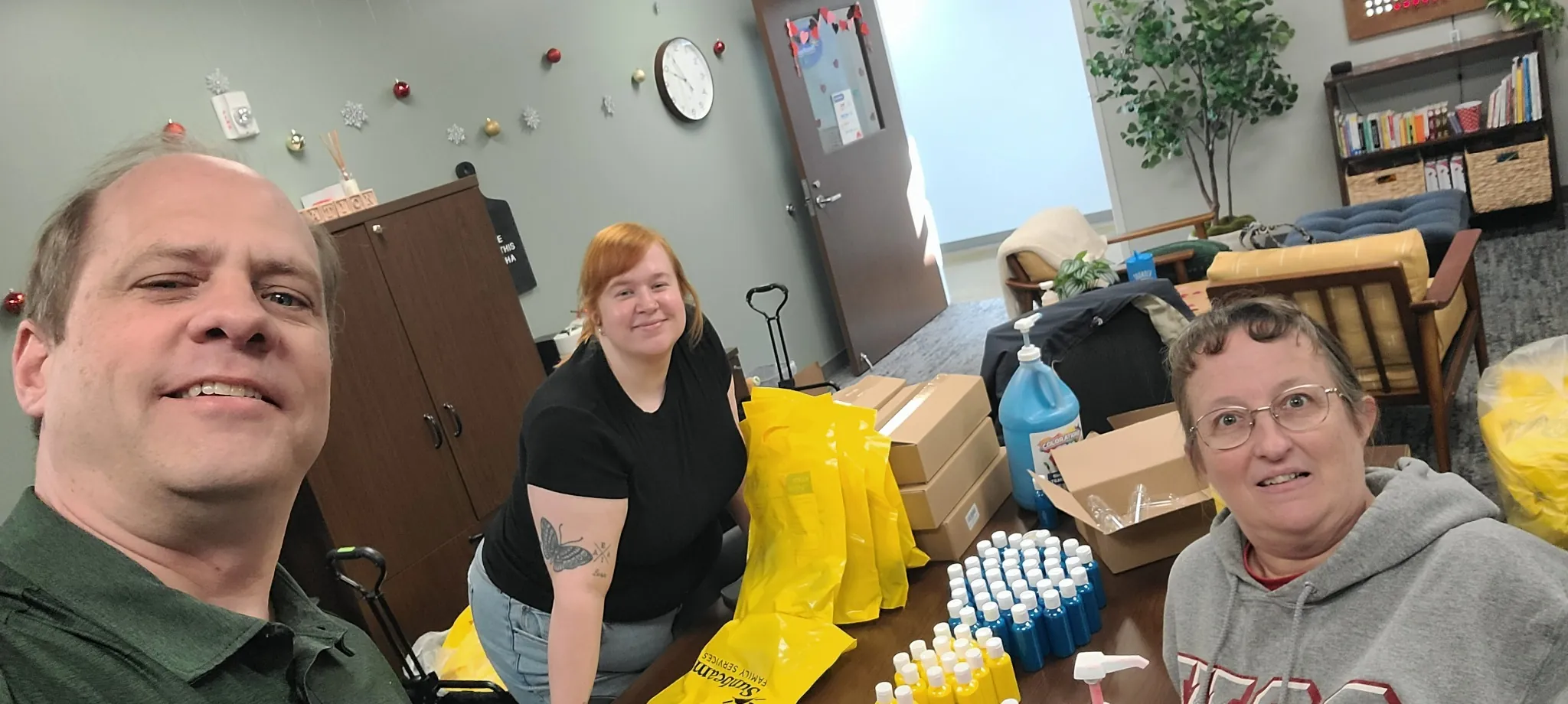 Todd and family preparing STEAM art kits at Sunbeam Family Services in Oklahoma City